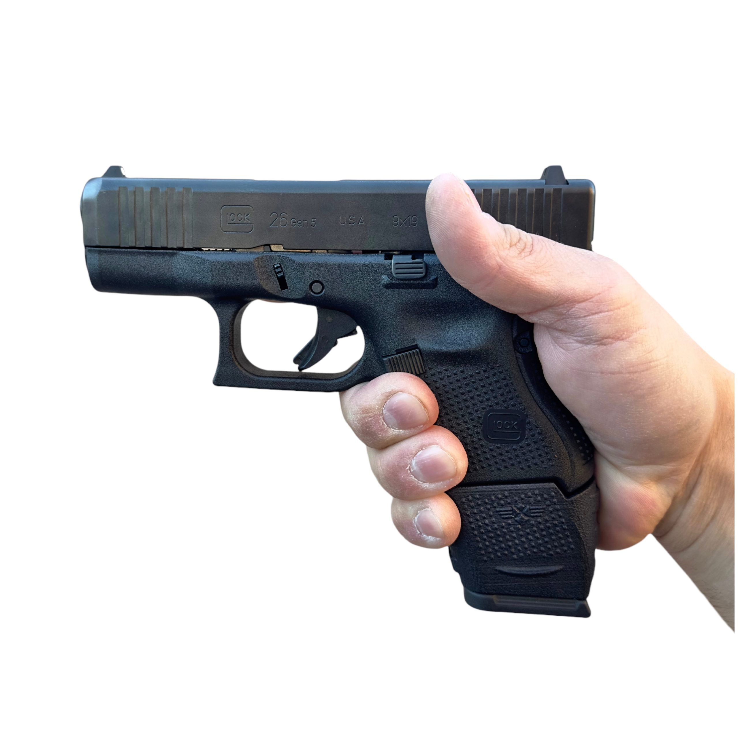 Glock 26 with 17 round magazine sleeve installed shown in hand in pistol