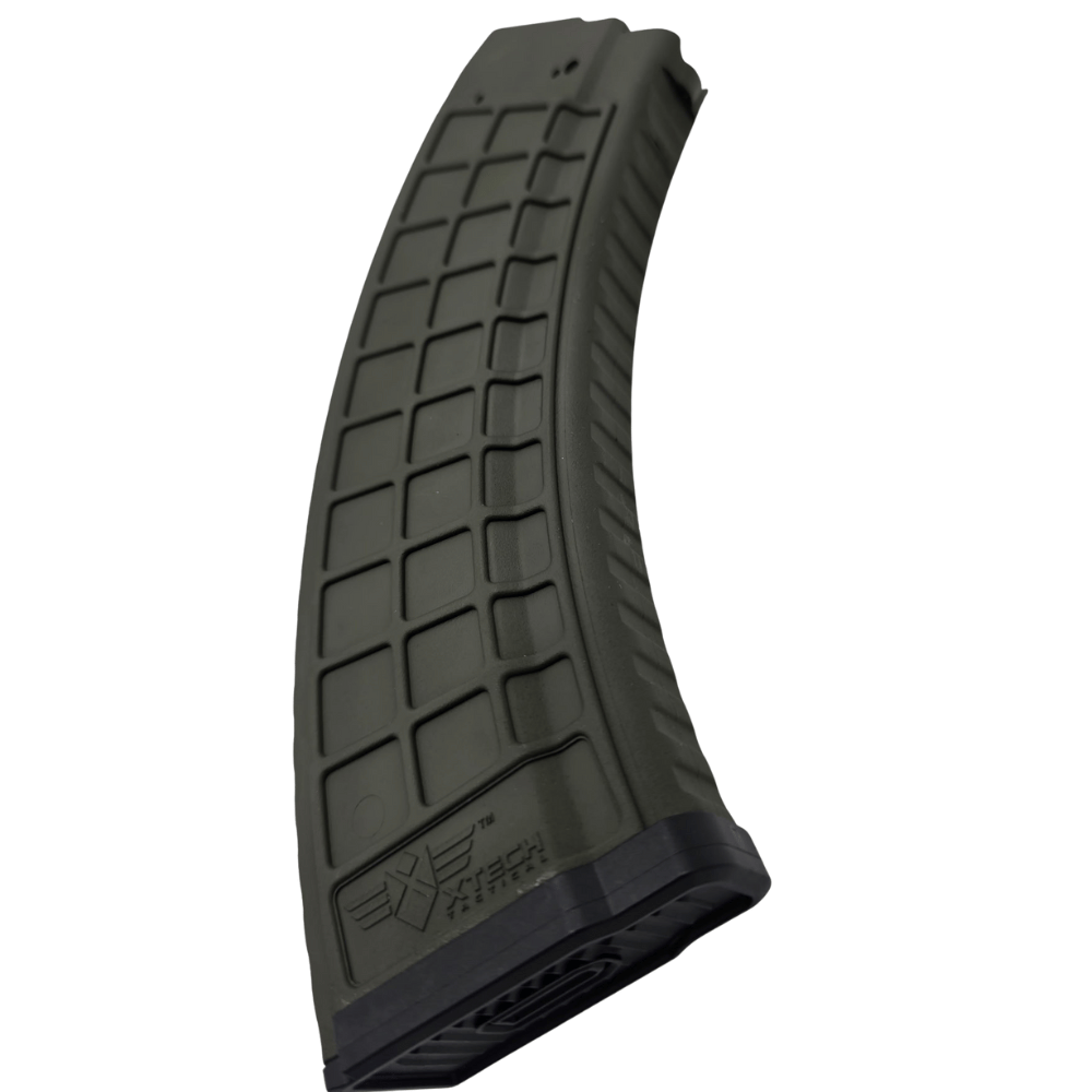 The XTech MAG47 Gen2 OD Green AK47 magazine features a dark green, curved body with a textured grid-like surface and an XTech Tactical logo near the base, shown isolated on a white background.
